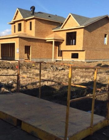 A house under construction with a ramp for accessibility.